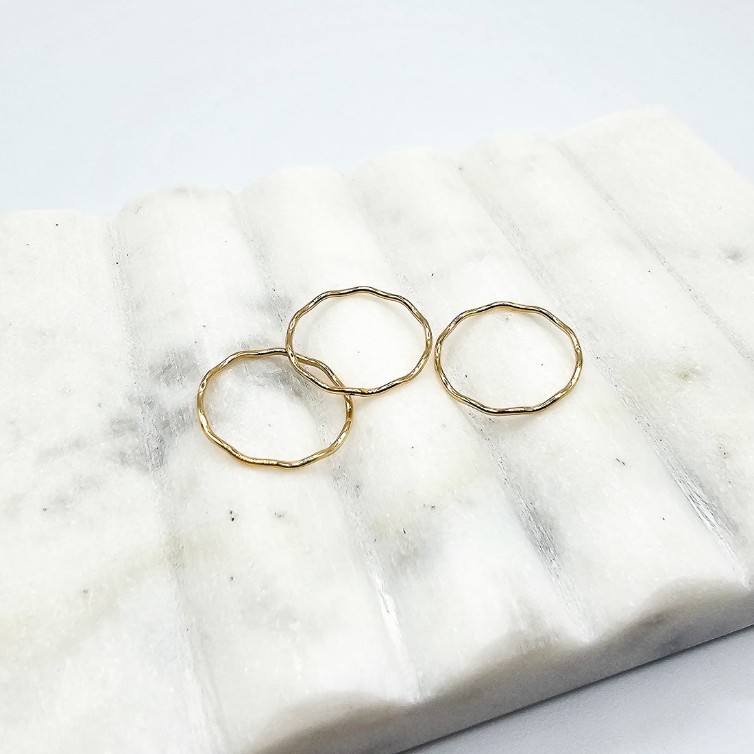 three 14k gold wave rings