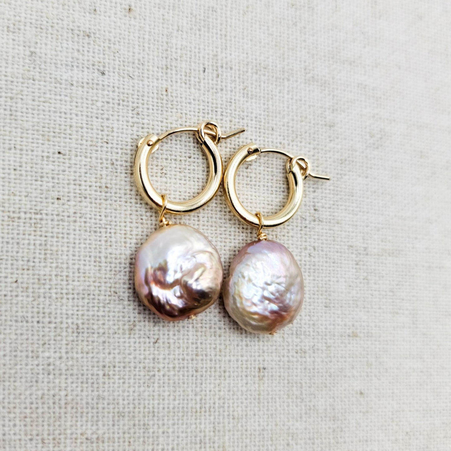 pink coin pearl hanging from 13mm gold filled hoops. 