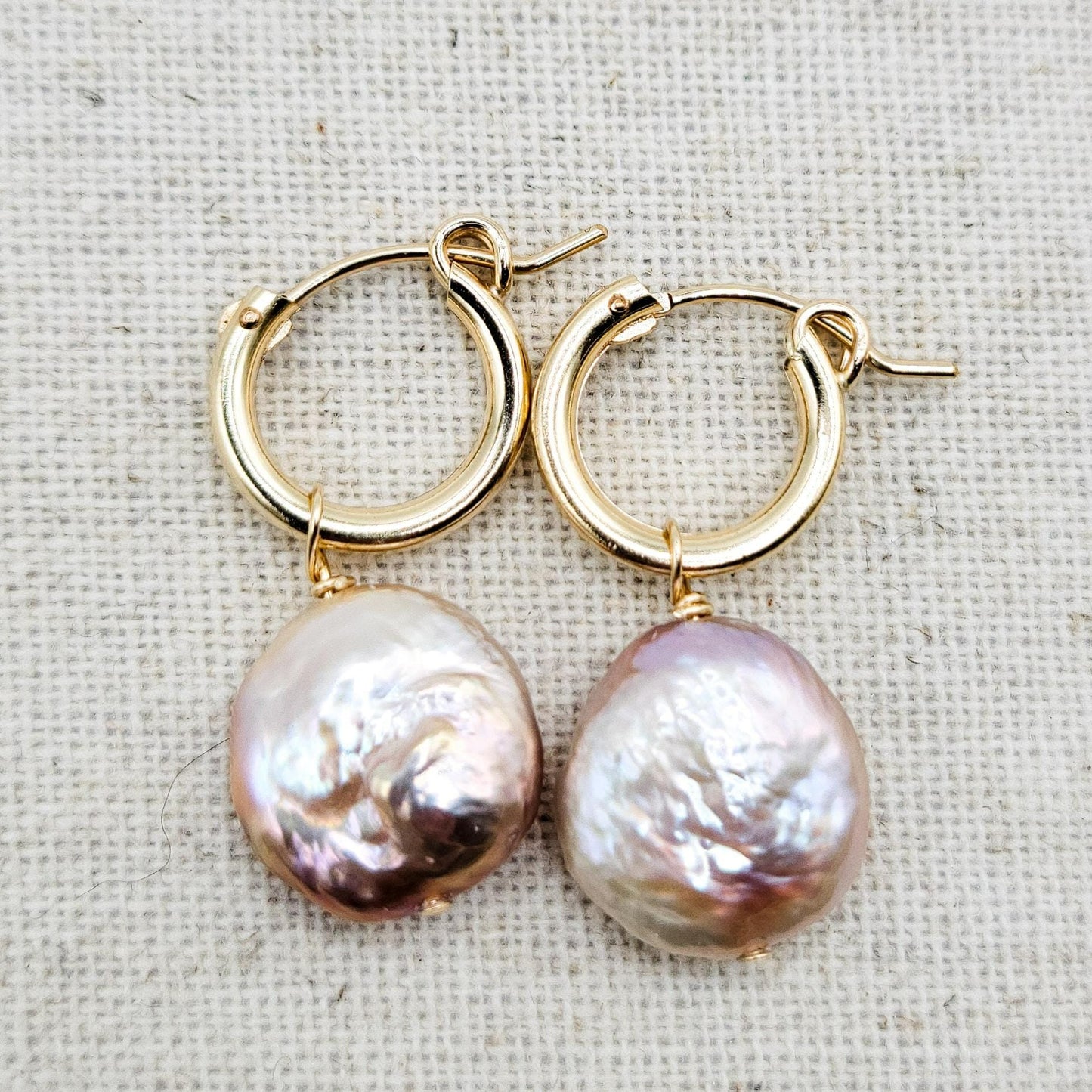 pink coin pearl hanging from 13mm gold filled hoops. 