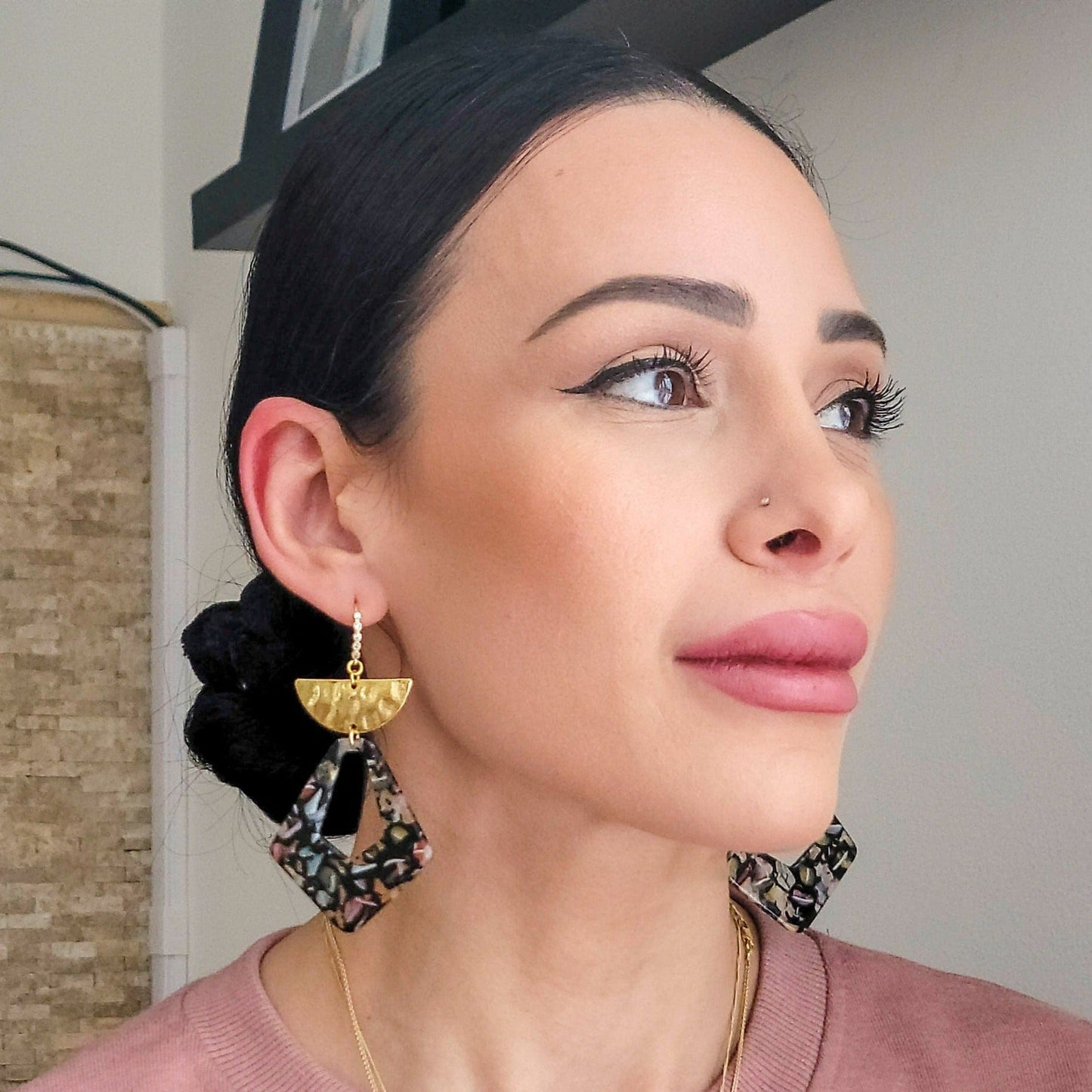 Seren and Skye Acetate Statement earrings on model. Earrings feature a tear drop space with half-moon hammered gold accent on a cubic-zirconia encrusted ear wire