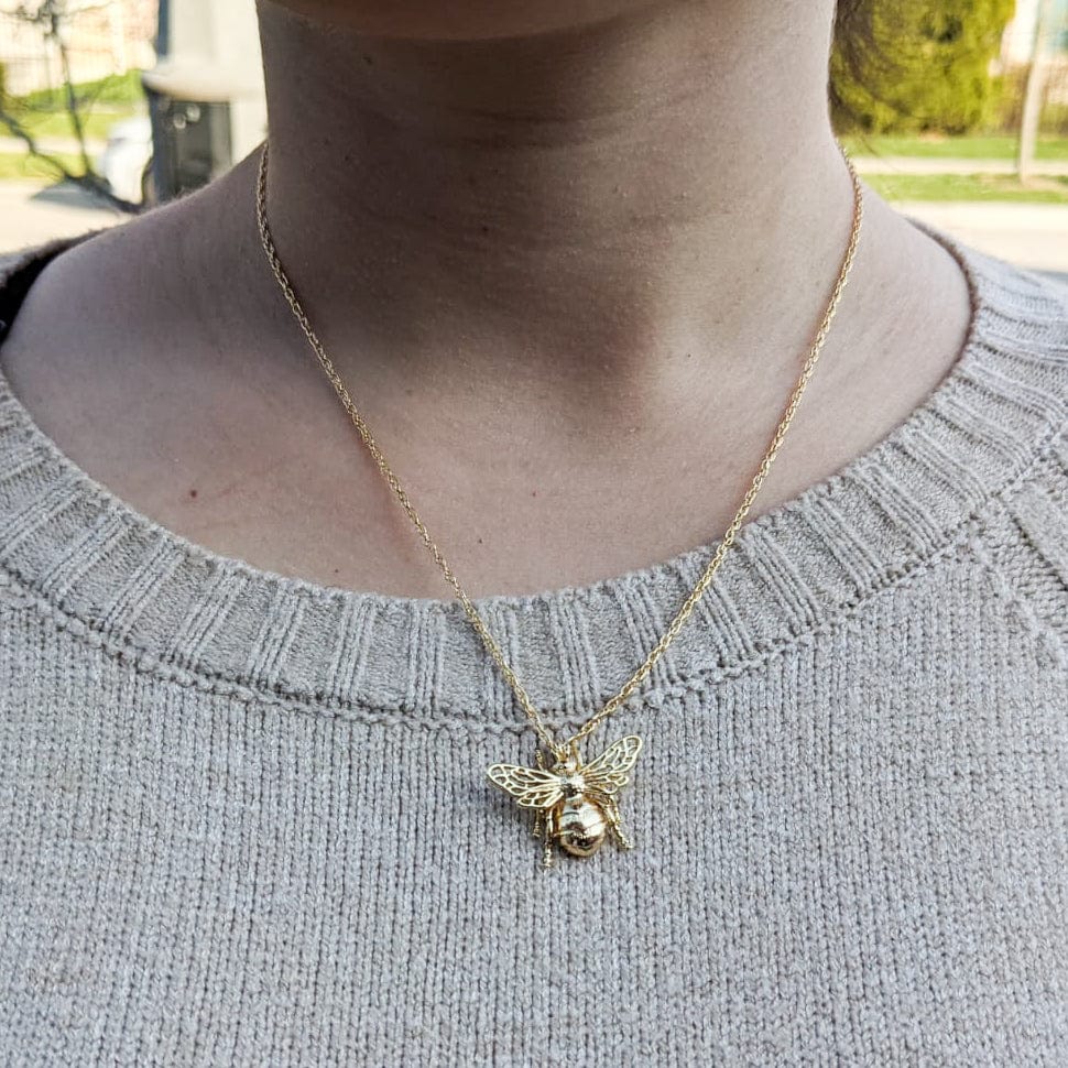 Gold plated bumble bee necklace on model. 14k gold filled chain with pendant. 